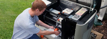 Generator service technician repairs Generac generator